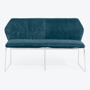 Modern minimalist sofa with deep blue velvet upholstery and chrome legs.