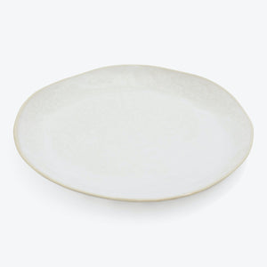 Simple and elegant off-white ceramic plate with a subtle rim.
