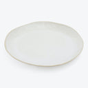 Simple and elegant off-white ceramic plate with a subtle rim.