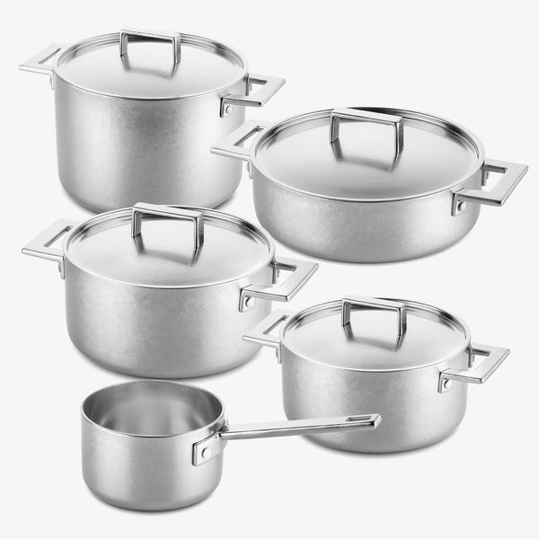 A set of shiny, new stainless steel cookware with modern design.