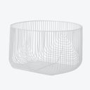 A contemporary wire basket with a minimalist design and versatile usage.