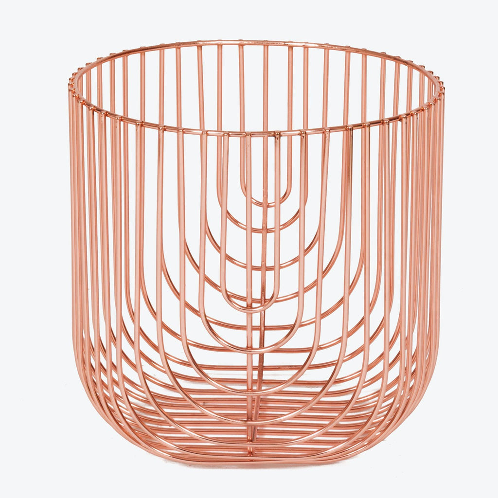 Copper-colored wire basket with interwoven rods for stylish storage.