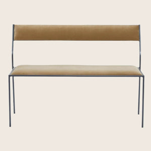 Contemporary steel bench with upholstered tan fabric, minimalist design.