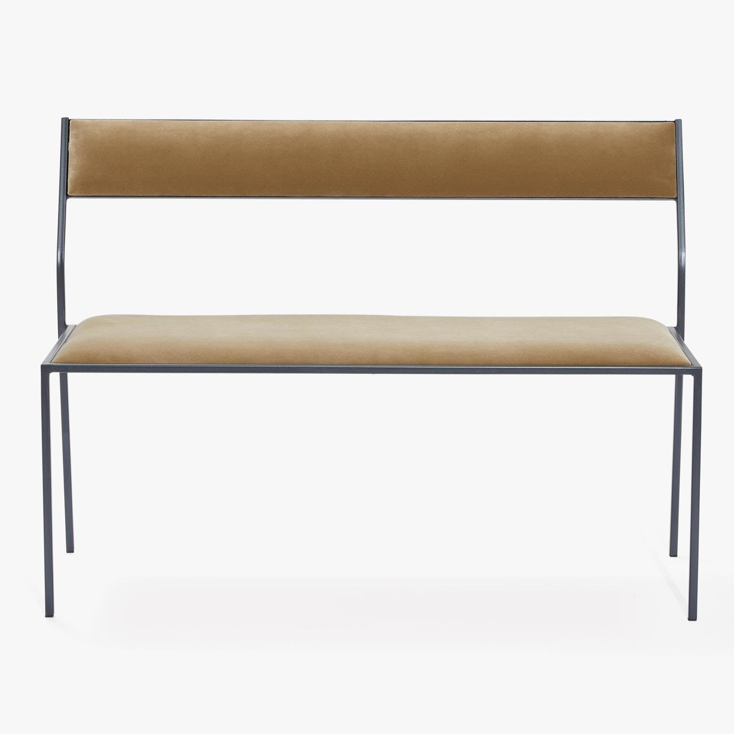 Contemporary steel bench with upholstered tan fabric, minimalist design.