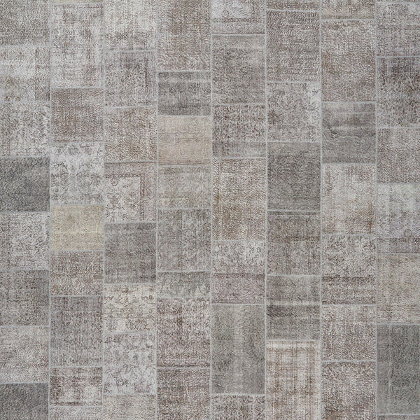 Patchwork pattern of rectangular tiles with shades of gray and beige