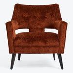 Modern armchair in burnt orange adds warmth to any space.