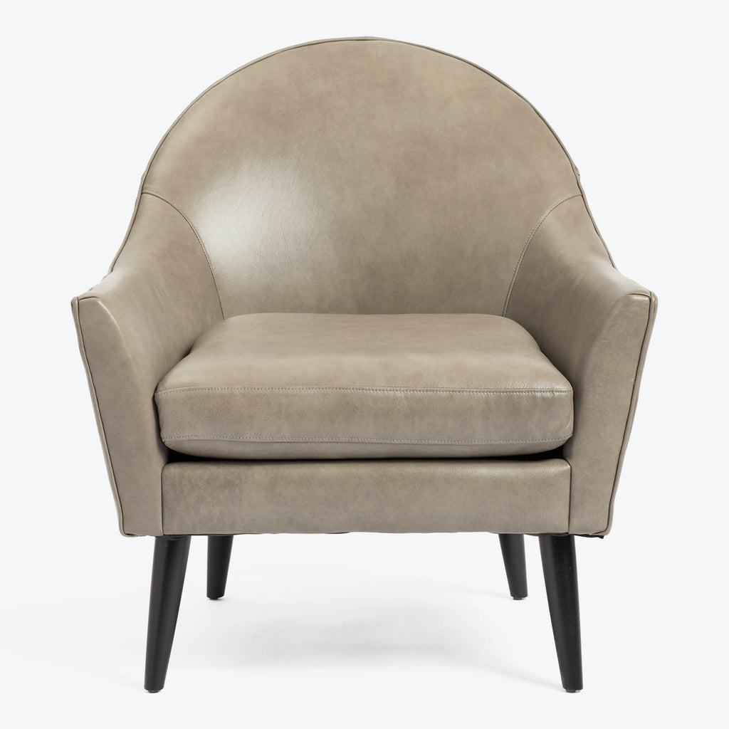 Modern armchair with high barrel back design - sleek and stylish.