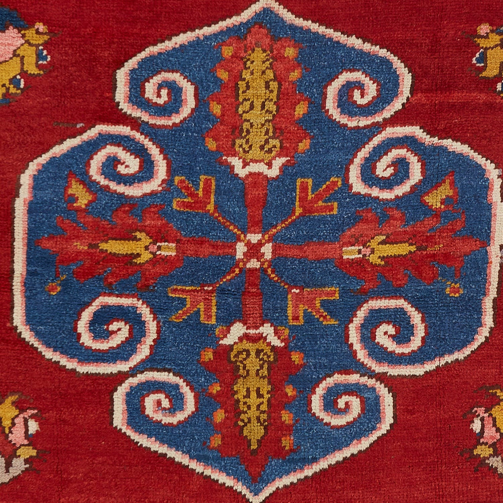 Detail of a intricately patterned textile showcasing vibrant colors and meticulous craftsmanship.