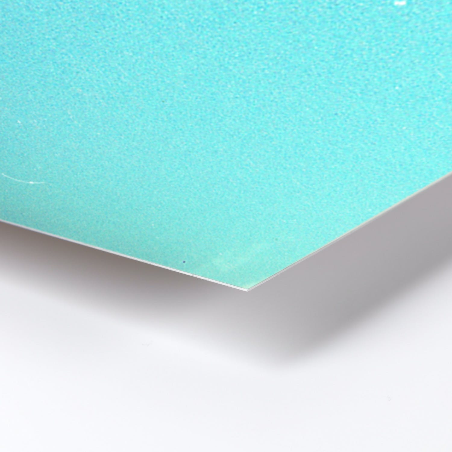 Close-up of light blue textured surface on paper or cardstock.