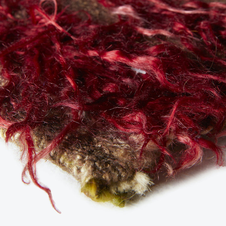 Close-up of textured fibrous material in rich burgundy and brown.