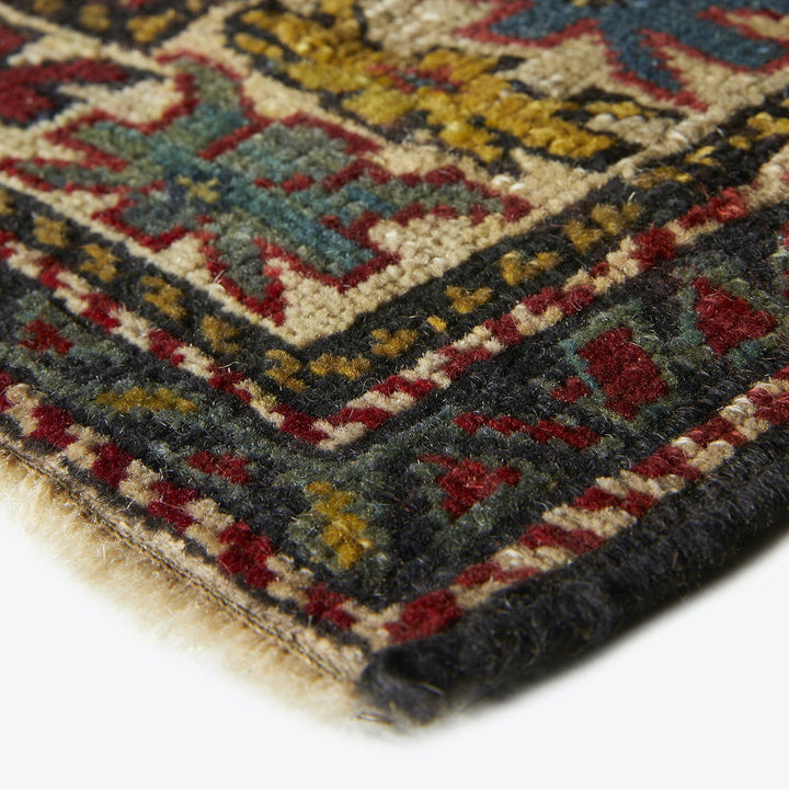 Close-up of a colorful, intricately patterned carpet showcasing detailed textures.