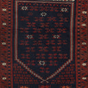 Traditional handwoven rug with intricate patterns in navy and red