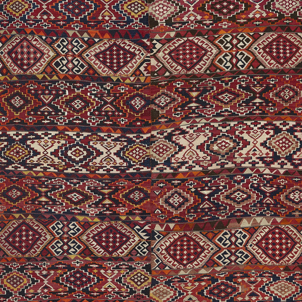 Intricate traditional rug showcases rich colors and geometric motifs.
