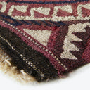 Close-up of a textured fabric with detailed woven geometric pattern.
