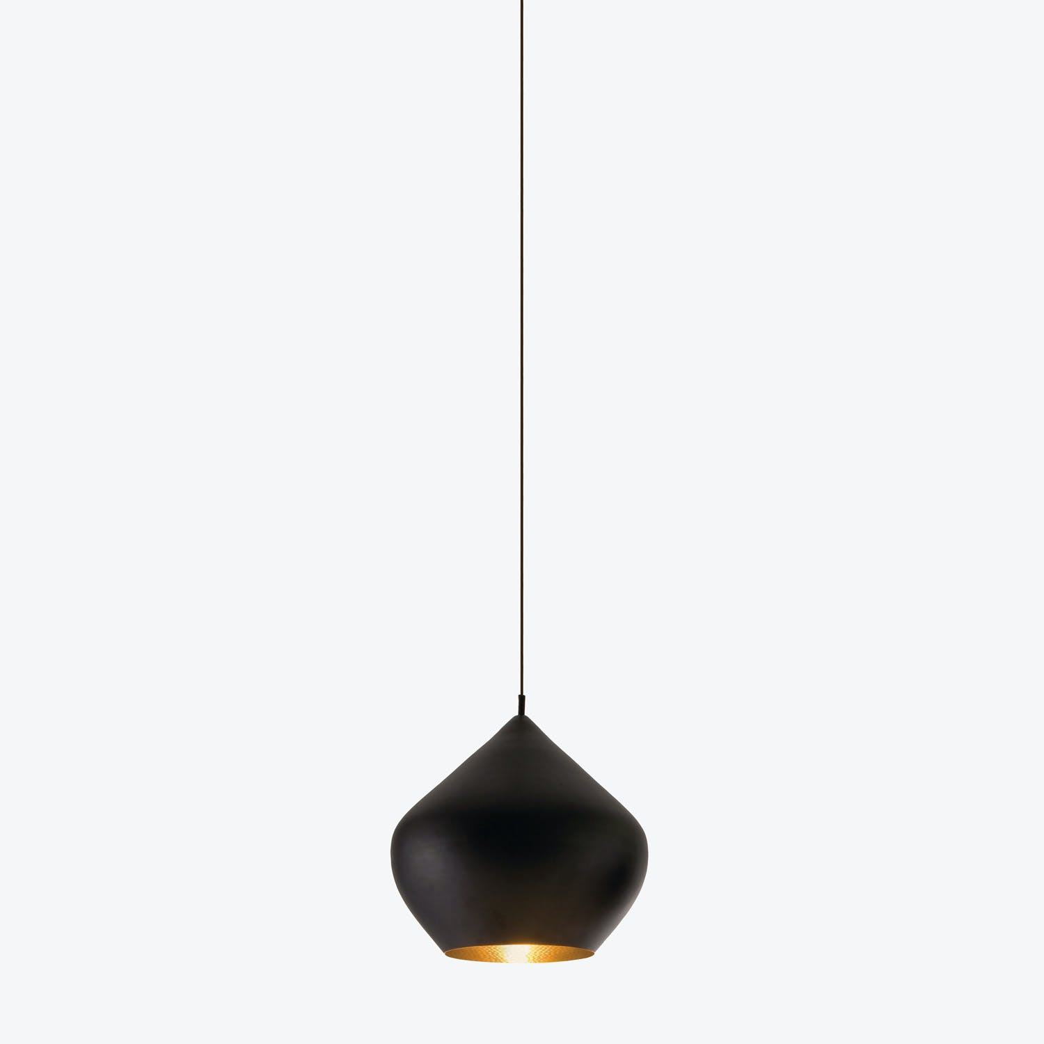 Contemporary pendant light with matte black finish emits warm glow.