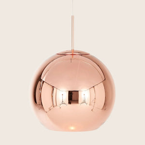 Sleek copper pendant lamp with modern design and illuminated glow.