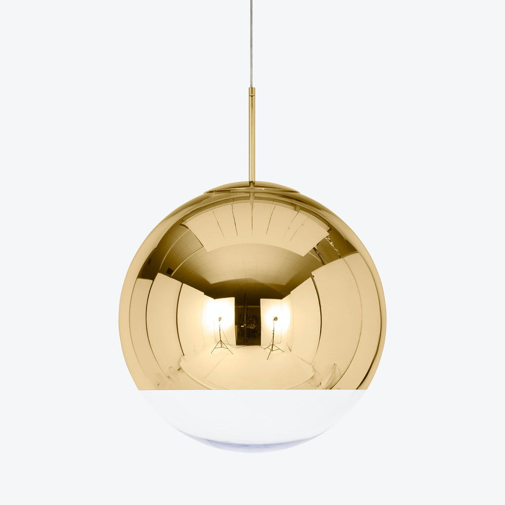 A modern pendant light with a reflective gold and white design.