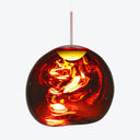 Vibrant red pendant light with fluid-like glass shade and chrome stem illuminates with fiery glow