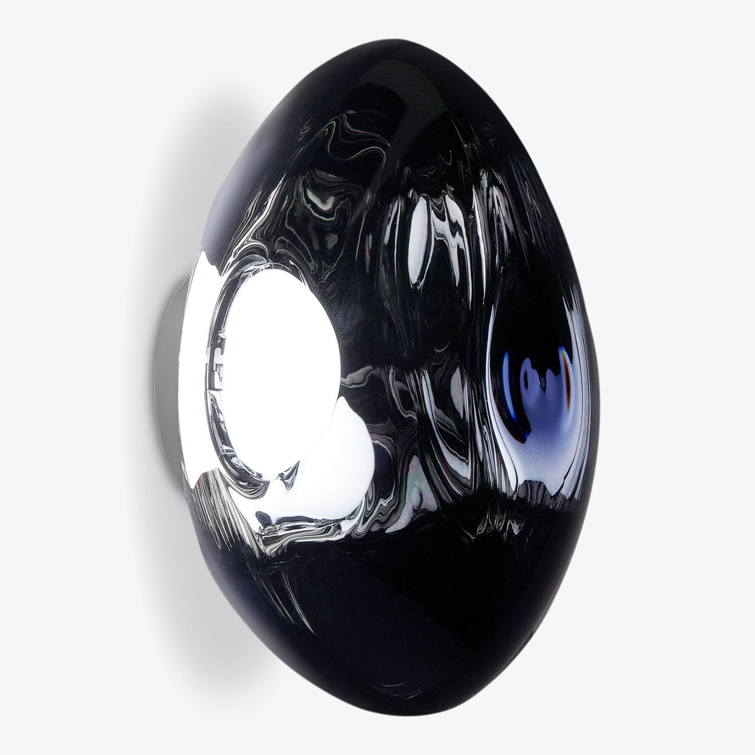 Hollow, reflective black sphere creates abstract, liquid-like light distortion.