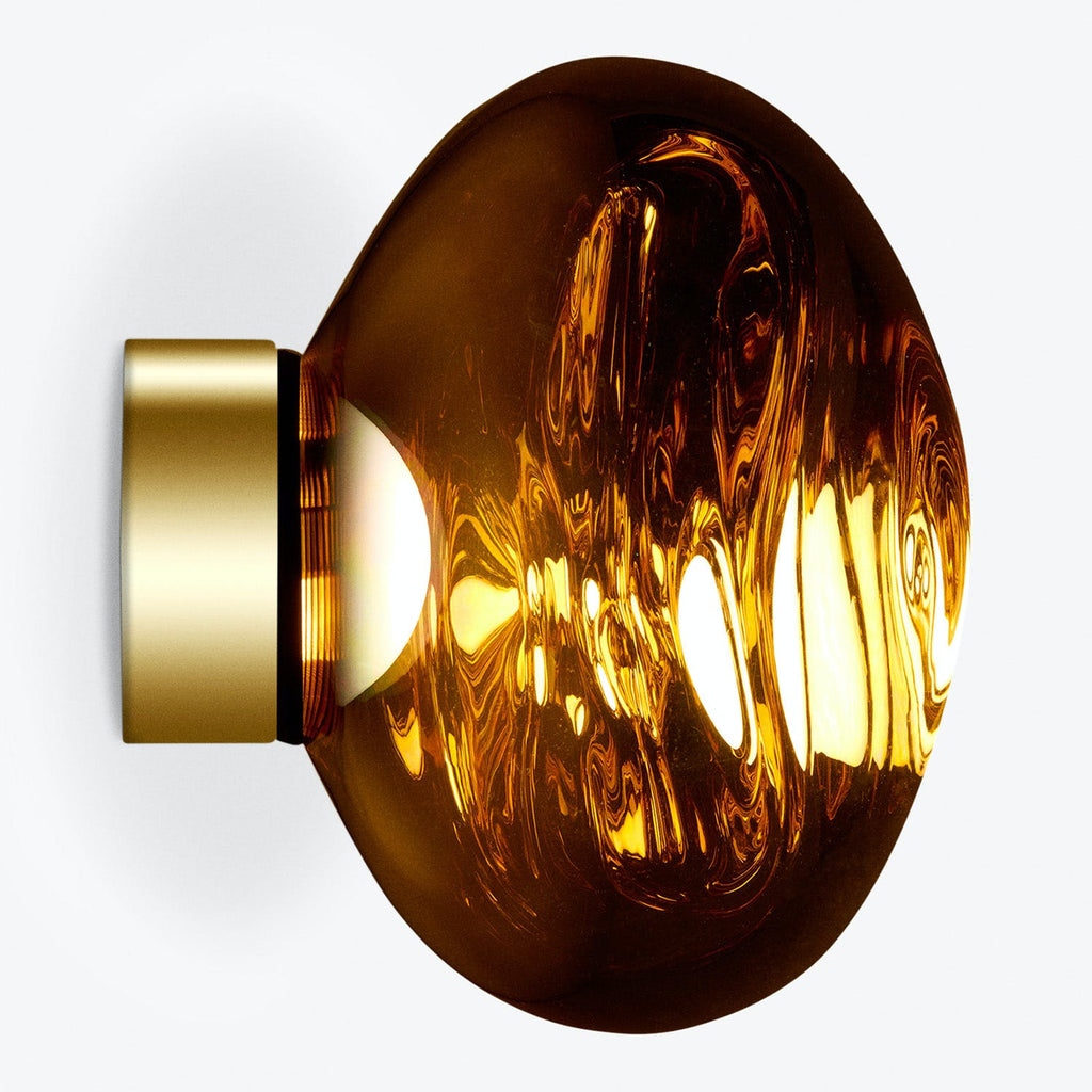 An amber glass lamp with intricate swirling patterns emanating warm light.