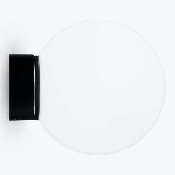 Minimalist white circular object with black rectangular attachment. Function ambiguous.