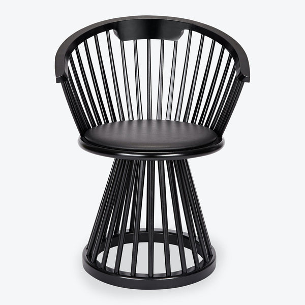 Modern black chair with unique cage-like design and sleek aesthetic.