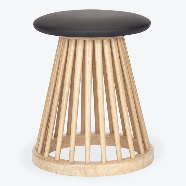 Contemporary stool with wooden dowel base and cushioned seat.