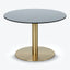 Contemporary round table with black top and golden pedestal stand.