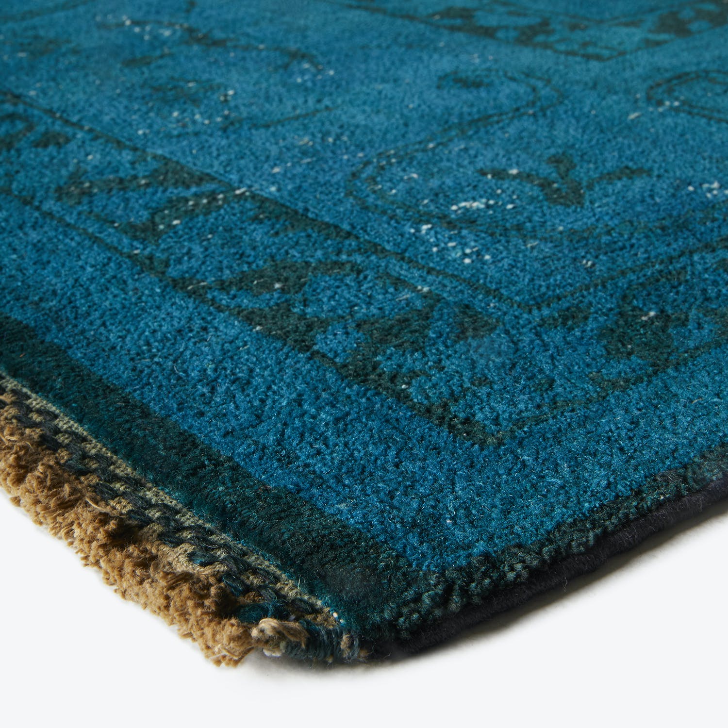 Close-up of luxurious deep blue carpet with subtle abstract design.