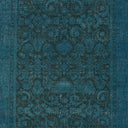 Elaborate teal blue fabric with ornate symmetrical pattern and metallic sheen.