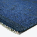 Close-up of a plush blue rug showing color variation and texture.