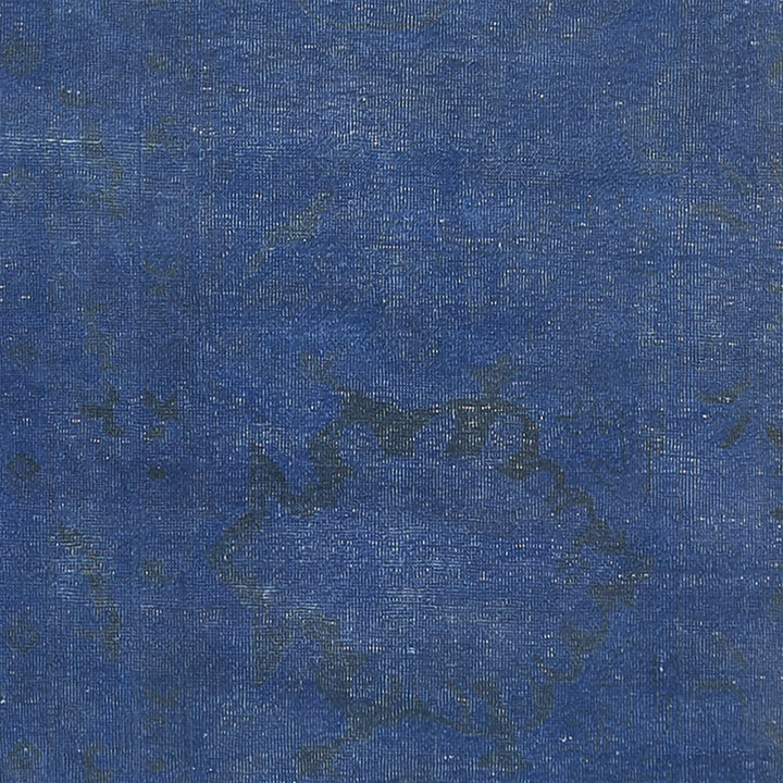 Close-up of blue denim fabric showcasing twill weaving pattern and texture.