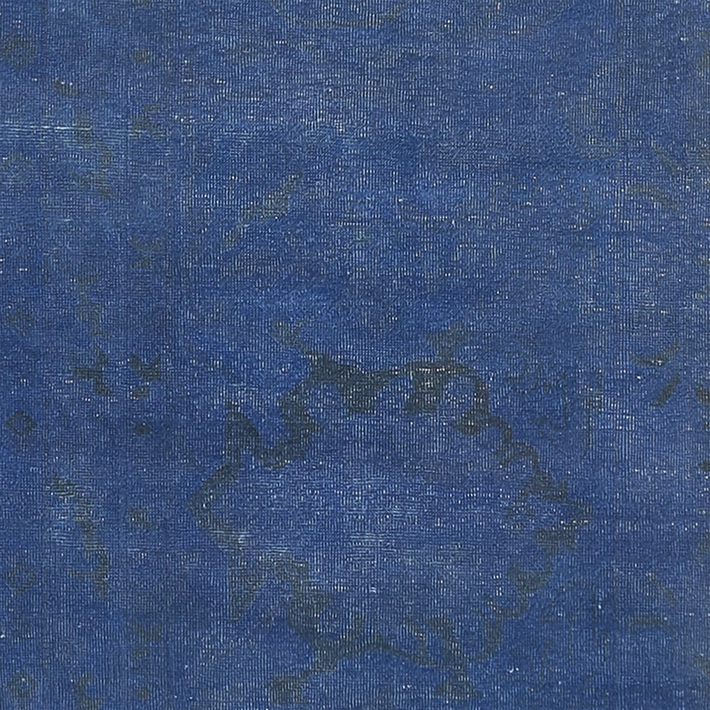 Close-up of blue denim fabric showcasing twill weaving pattern and texture.