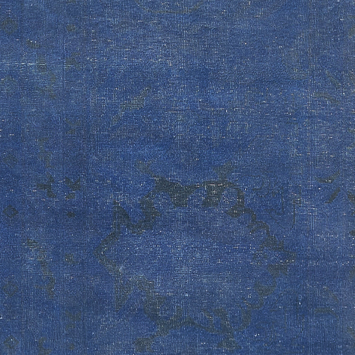 Close-up of blue denim fabric showcasing twill weaving pattern and texture.