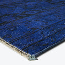Close-up of a rich blue carpet with textured appearance.