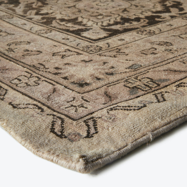 Close-up of a traditional area rug with intricate floral patterns.