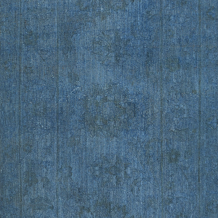 Close-up of worn and stone-washed denim fabric texture.