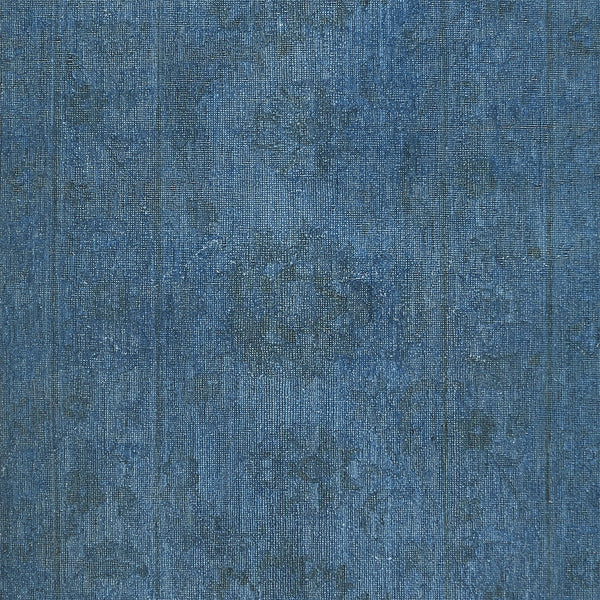 Close-up of worn and stone-washed denim fabric texture.