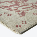 Textured rug with cream base, geometric pattern and mauve abstract shapes