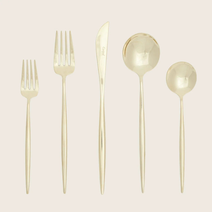 Neatly arranged gold flatware set with sleek, modern design