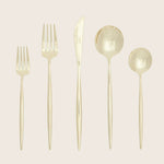 Neatly arranged gold flatware set with sleek, modern design