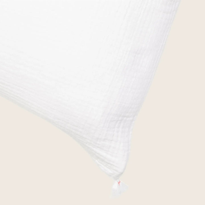 White textured pillow with gusseted edge and woven fabric pattern.
