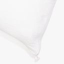 White textured pillow with gusseted edge and woven fabric pattern.