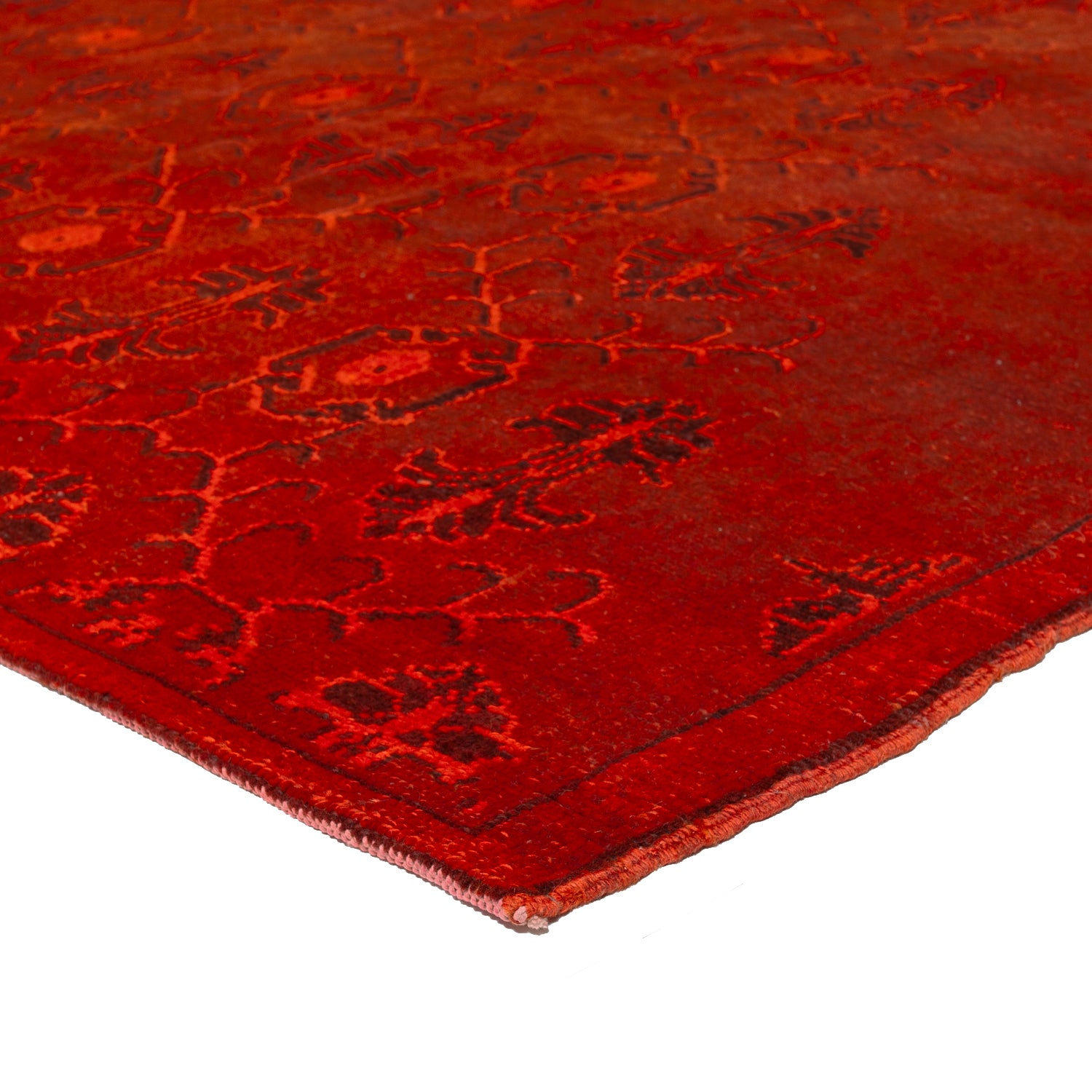 Intricate red carpet with symmetrical botanical patterns exudes elegance.