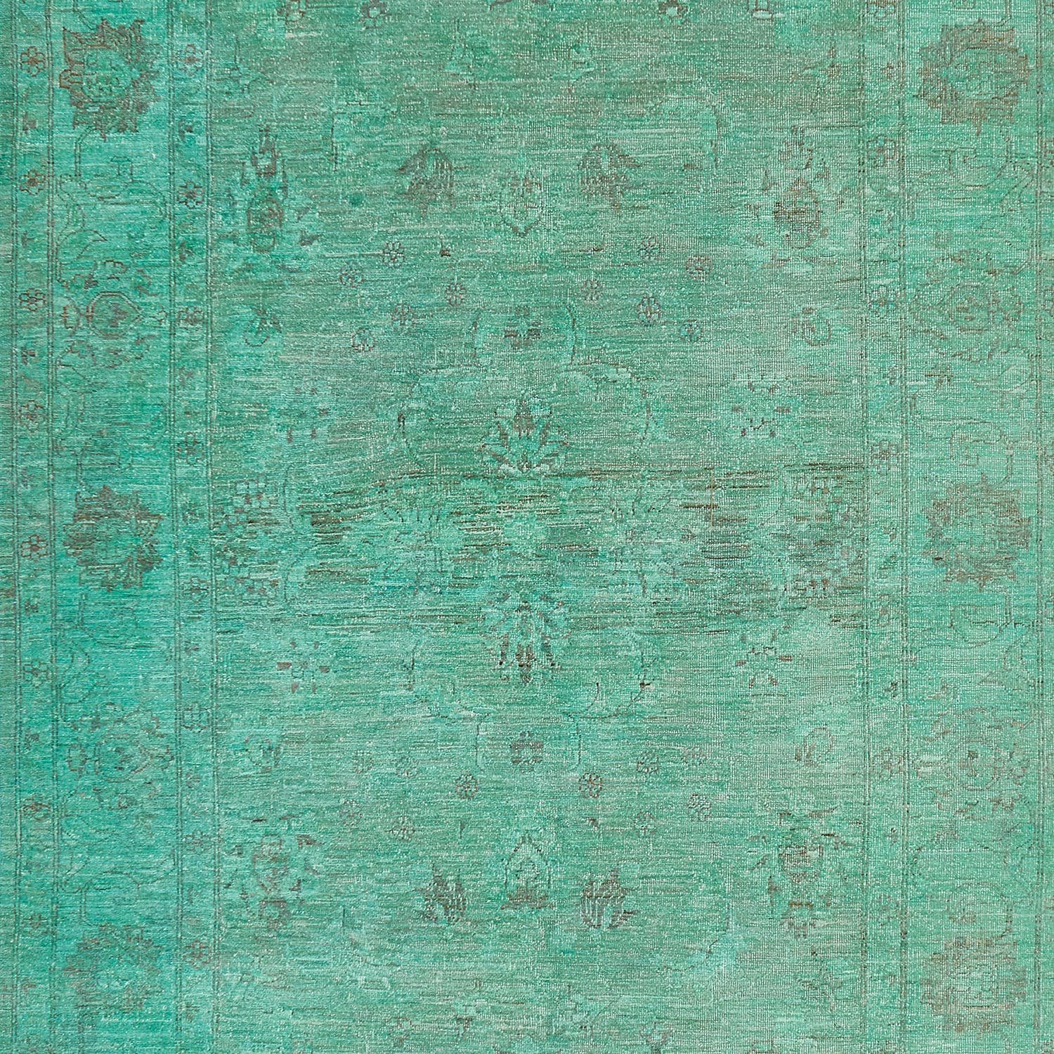 Vintage turquoise textured surface with symmetrical floral motifs for design.