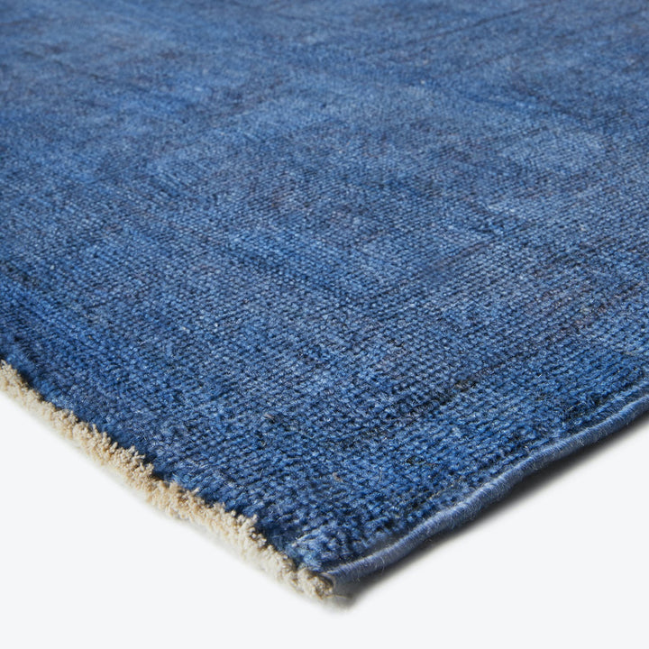 Close-up view of a gradient blue rug showcasing intricate craftsmanship.