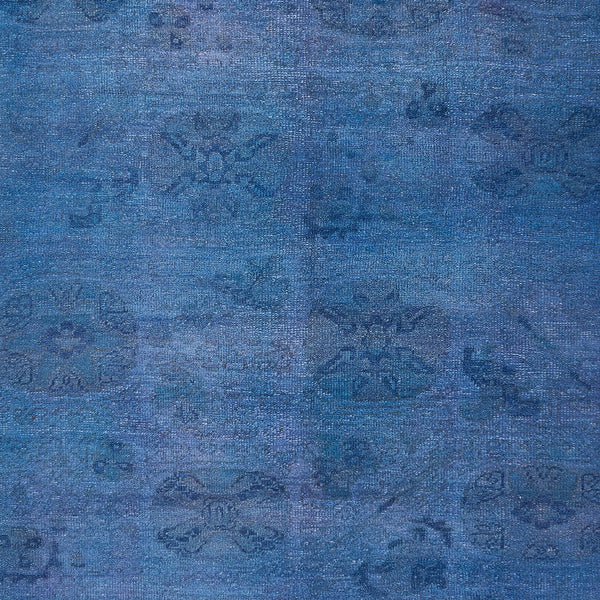 Vintage blue fabric with weathered, floral pattern for elegant decor.