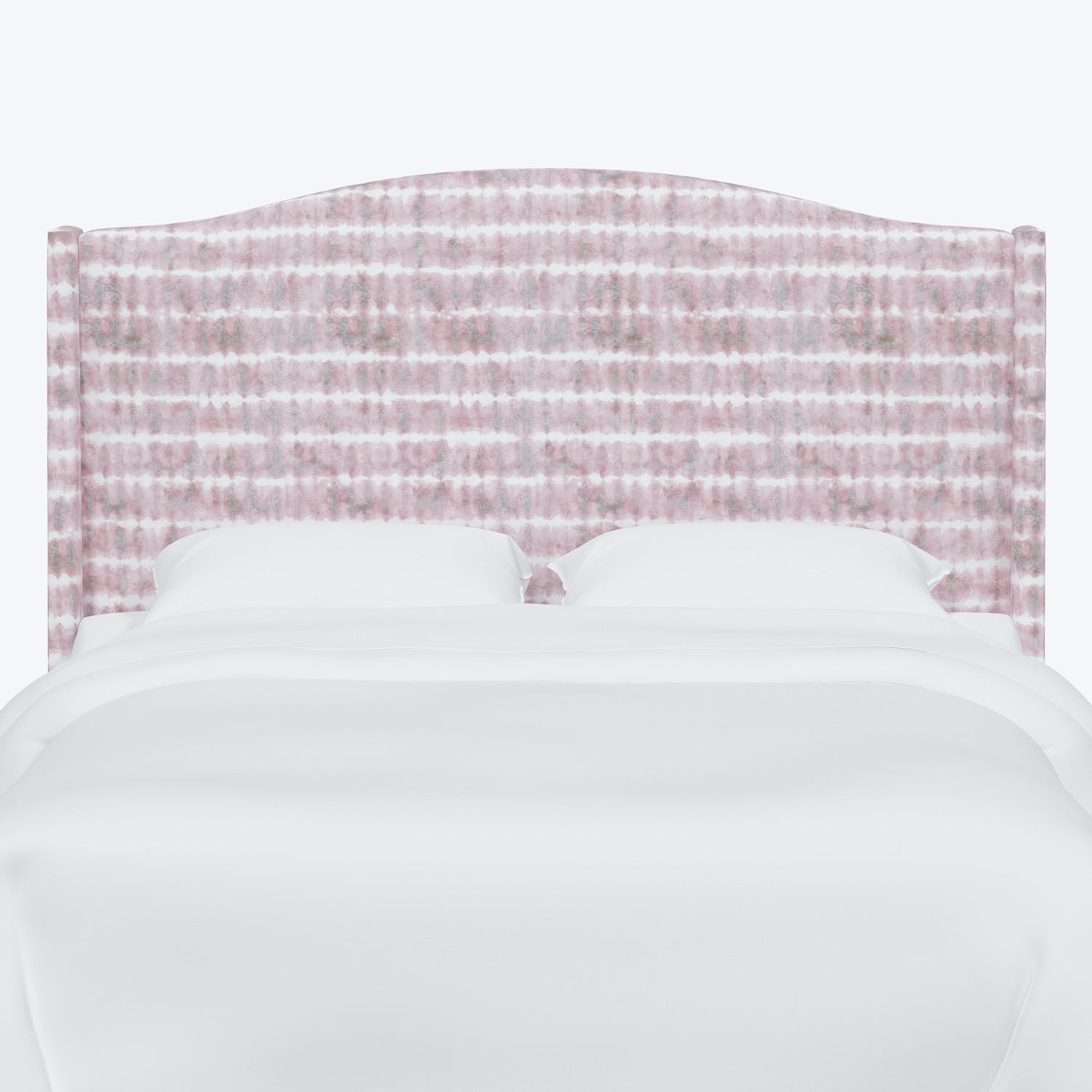 A pink and white patterned headboard on a neatly made bed.