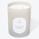 Luxurious scented candle in a glass container with elegant design.