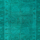 Teal and turquoise fabric with irregular texture and abstract pattern.